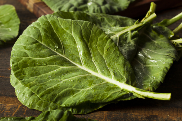 Photo of freshly washed collard greens on a table.
